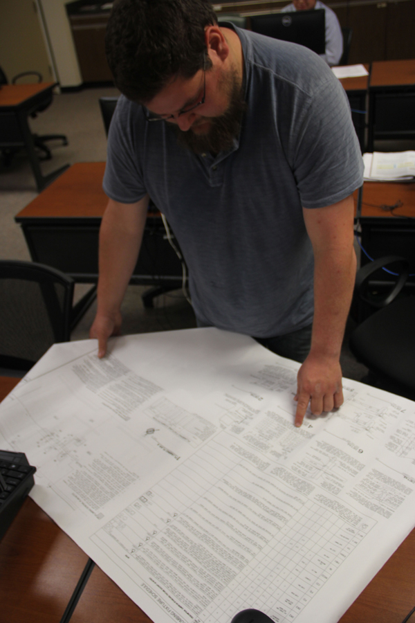 Student Kevin Ingram looks at building plans.