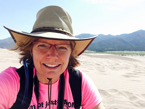 Photo of Dr. Diane Neudorf on a sand dune.