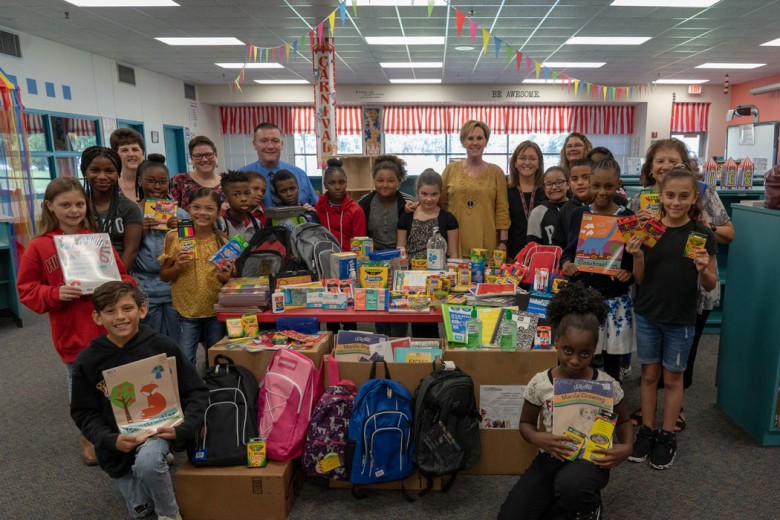 Group of school kids receiving an assortment of school supplies