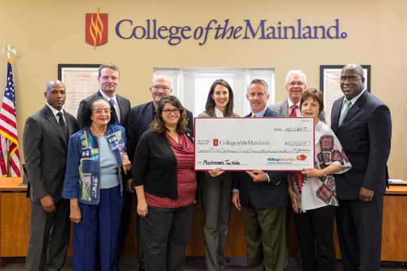 COM Trustees hold check representing $16.19 million maintenance bond