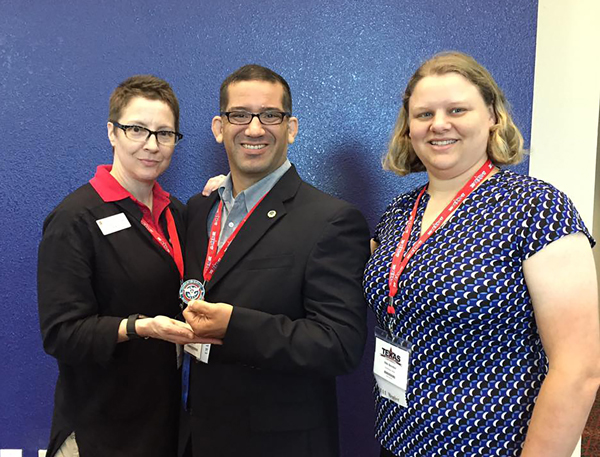 Camilo Olivieri, center, is COM’s first Emergency Management Program certificate graduate. From left, Trish McIntosh, program coordinator, Olivieri and Nicki Bender, program instructor.