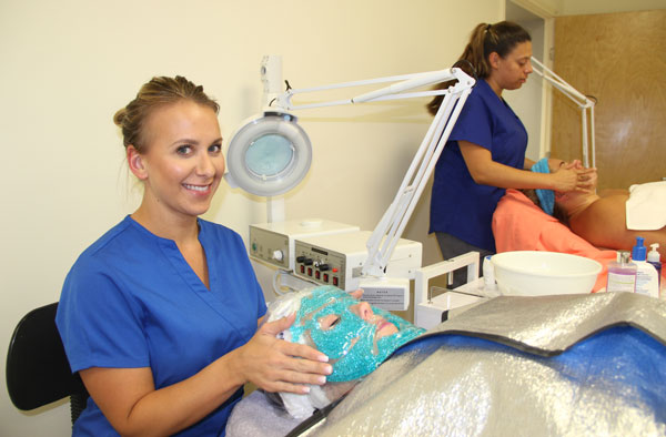 A cosmetology student performs a facial