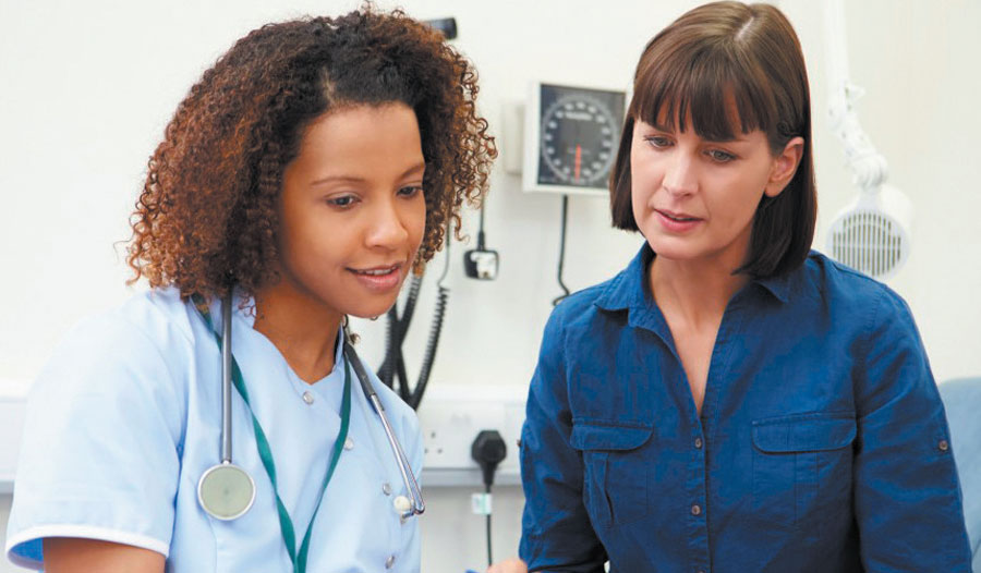 Medical Assistant student training with an instructor in the school medical lab