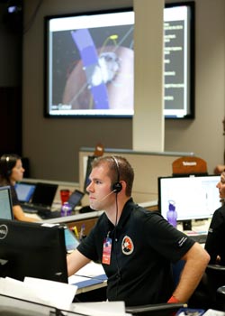 Photo of Dr. Andrzej Stewart in a control center