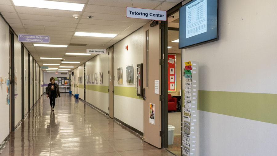 Student walking down the hall towards the tutoring center entrance.